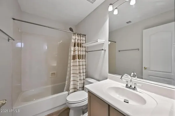 a bathroom with a sink mirror toilet and bathtub