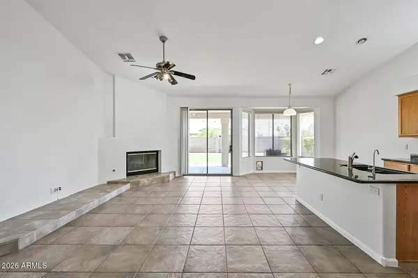 a large kitchen with granite countertop a sink and a stove