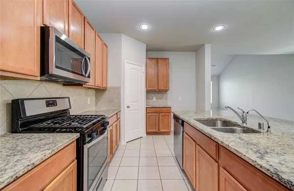 a kitchen that has a sink and a stove