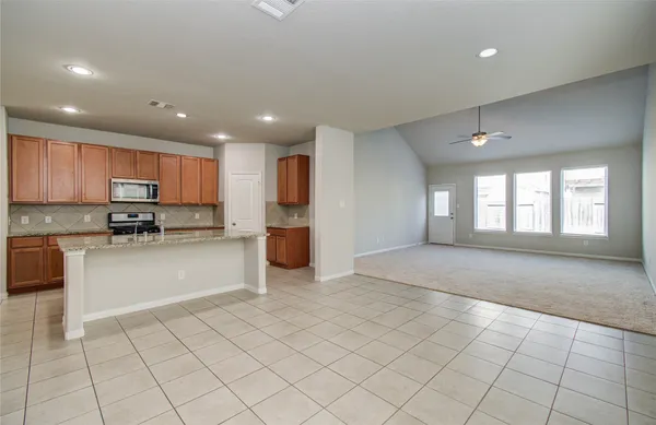 a view of a livingroom with a ceiling fan and window