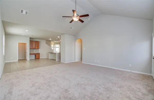 a view of a livingroom with a ceiling fan and window