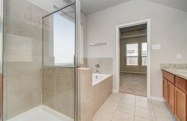 a bathroom with a bathtub and a shower