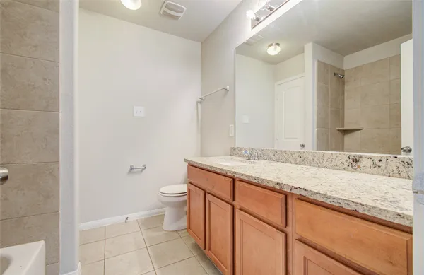 a bathroom with a tub sink and a mirror