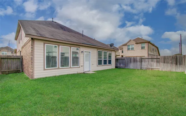 a view of a backyard with wooden fence