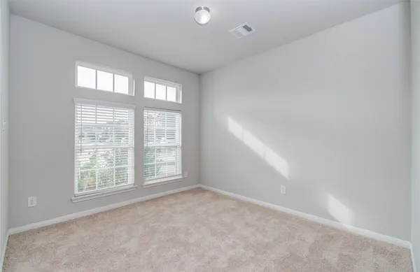 an empty room with wooden floor and cabinet