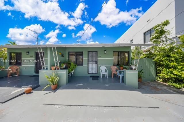 a dining room with furniture and a potted plant