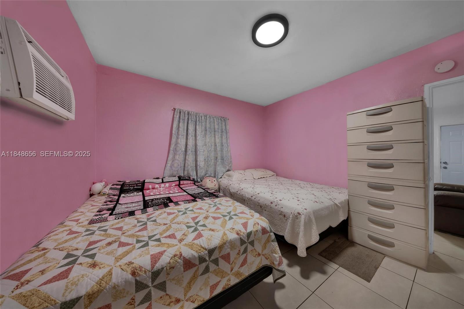 1858 Southwest 5th Street Miami, FL 33135 - Photo 12 of 23 a bedroom with a bed and a window