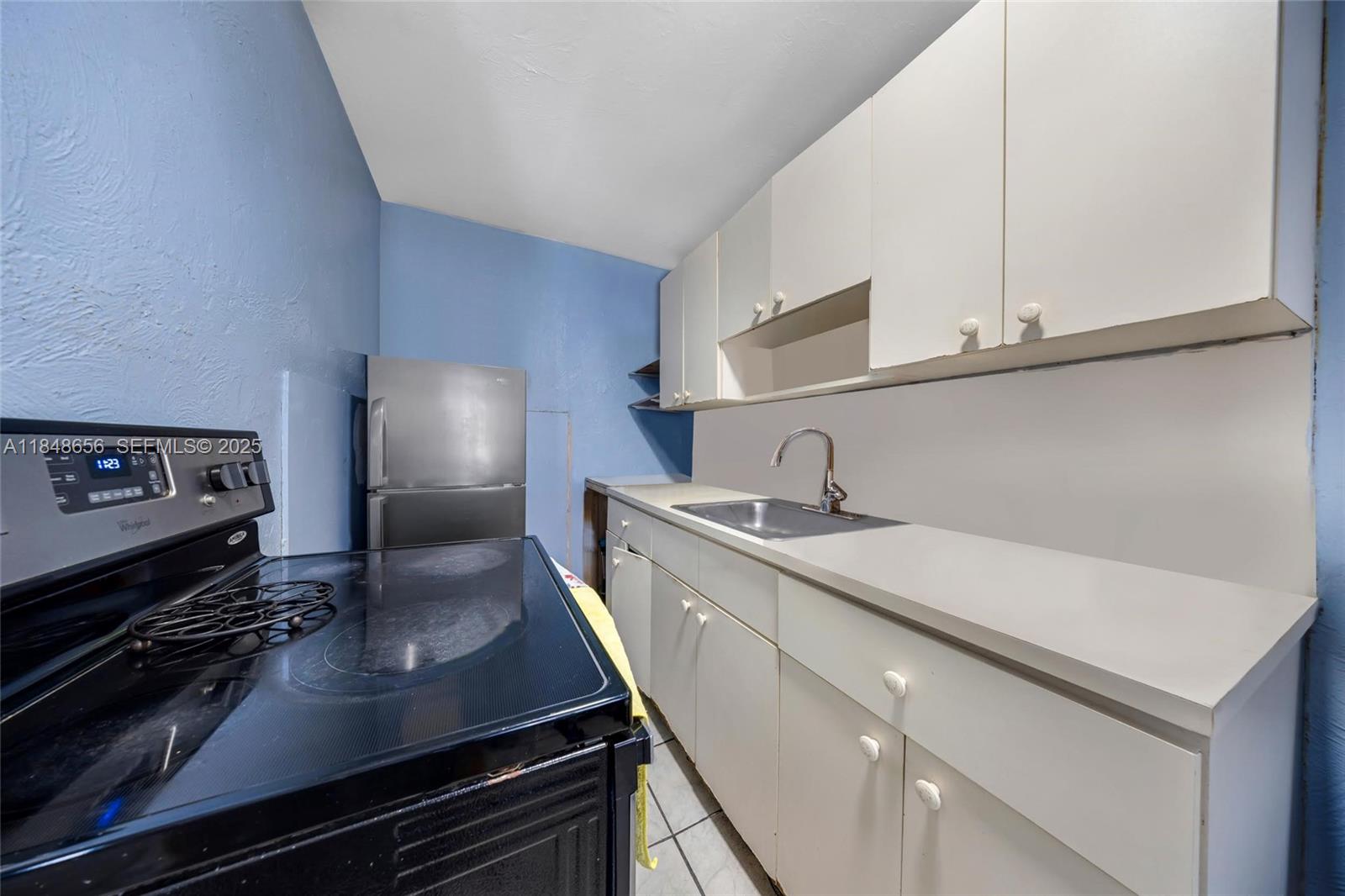 1858 Southwest 5th Street Miami, FL 33135 - Photo 15 of 23 a kitchen with a sink stove and cabinets