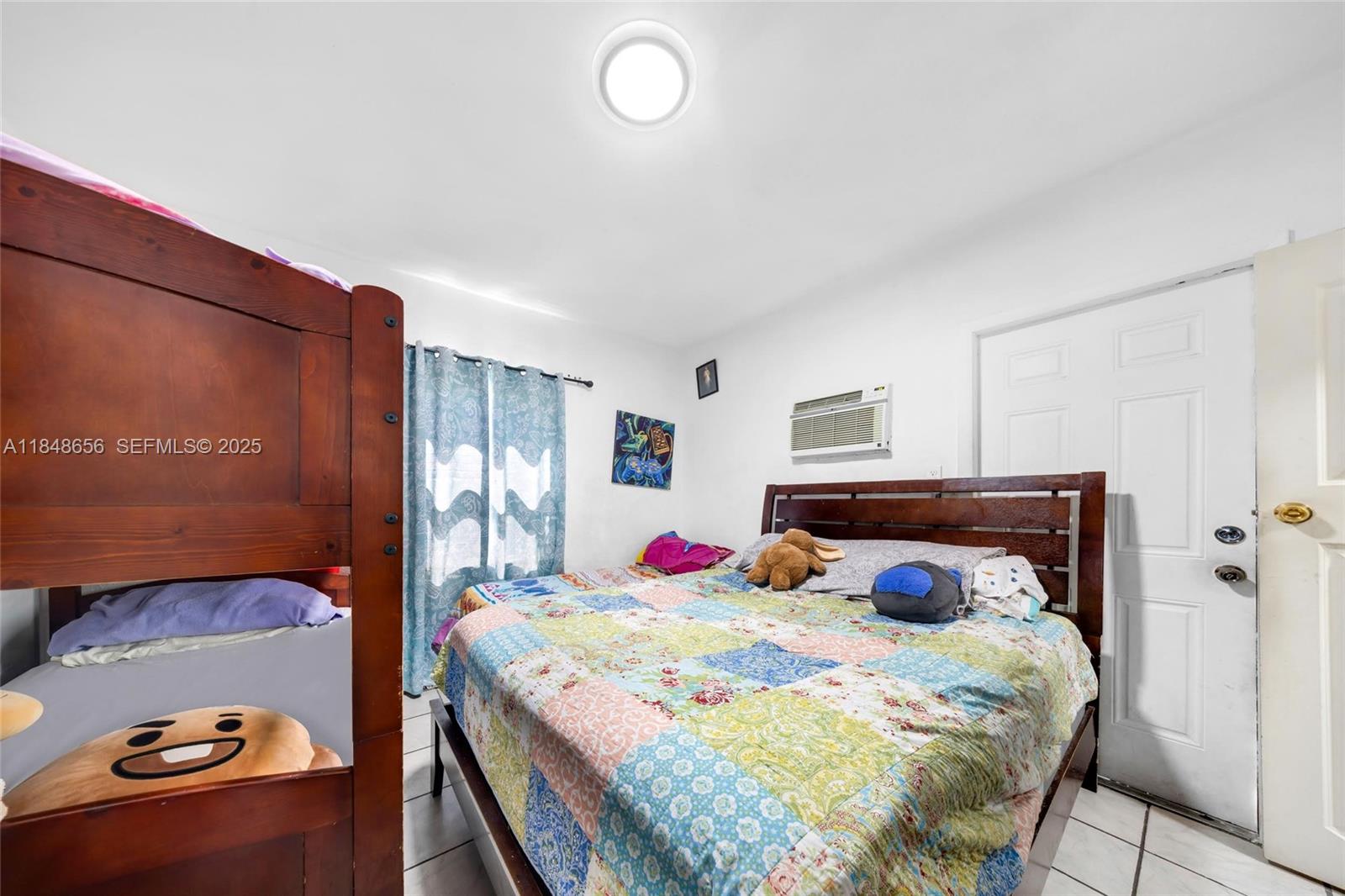 1858 Southwest 5th Street Miami, FL 33135 - Photo 16 of 23 a bedroom with a bed and a potted plant