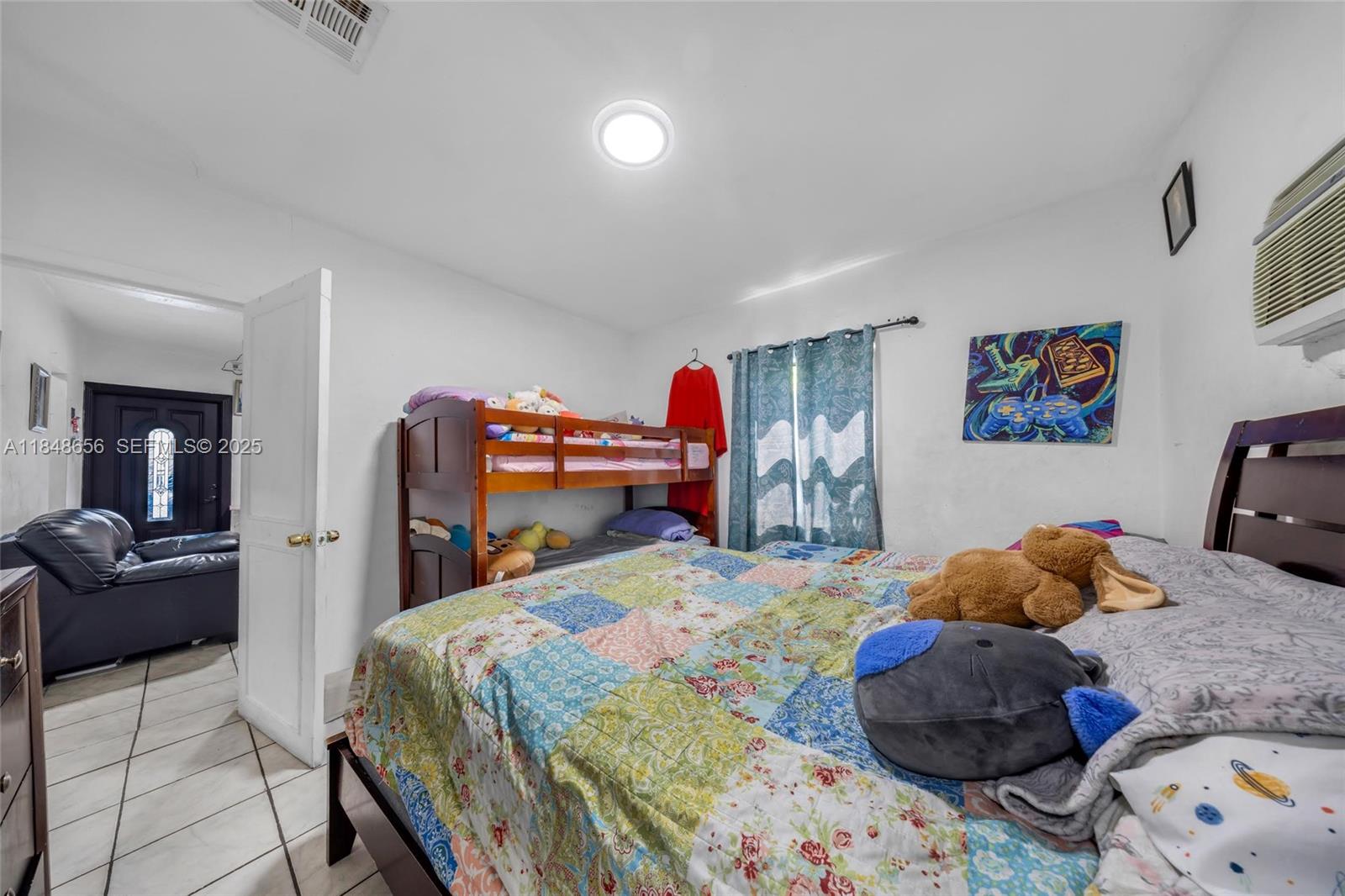 1858 Southwest 5th Street Miami, FL 33135 - Photo 17 of 23 a bedroom with a bed and cabinets