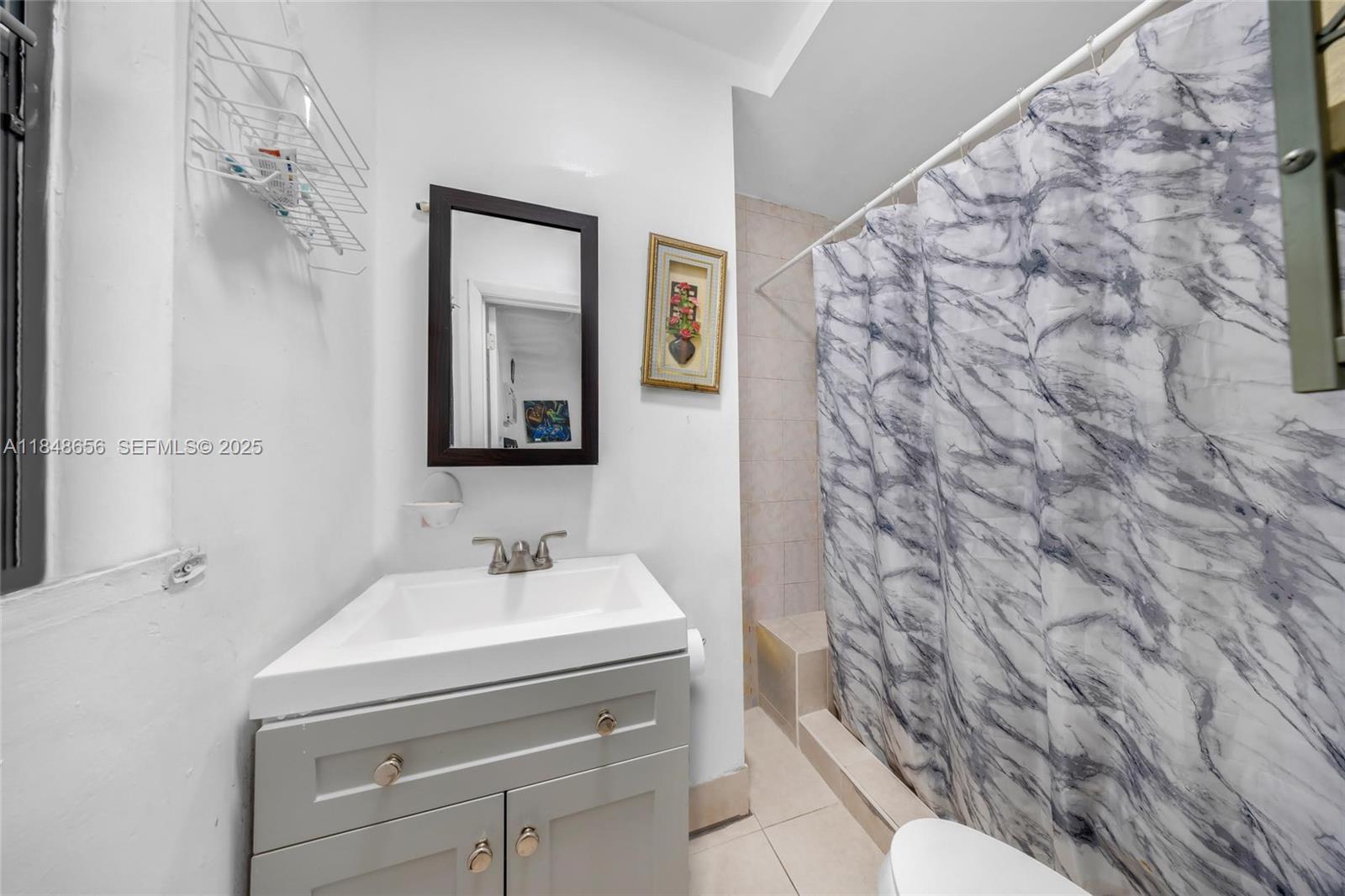1858 Southwest 5th Street Miami, FL 33135 - Photo 18 of 23 a bathroom with a sink and a mirror