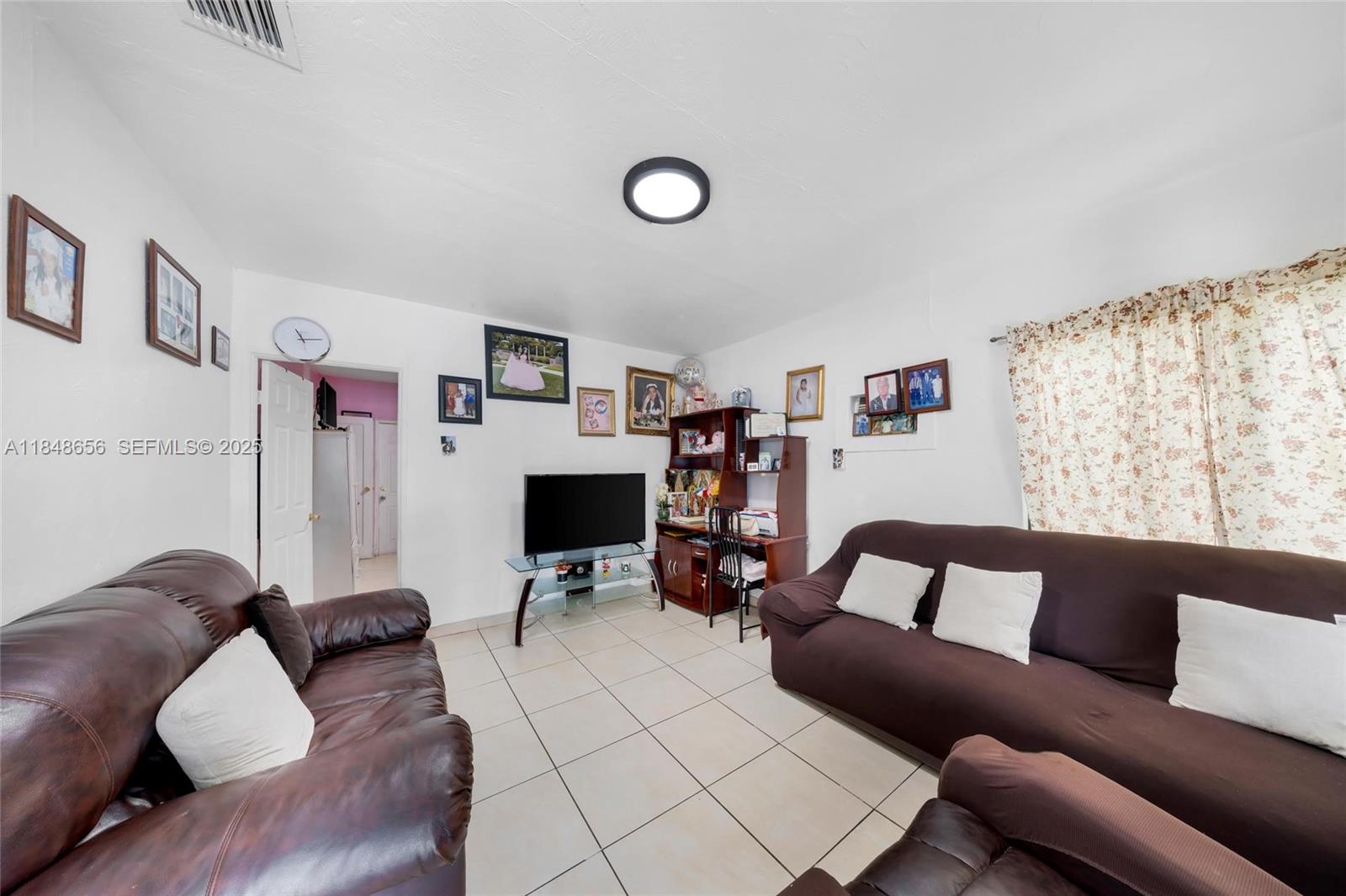 1858 Southwest 5th Street Miami, FL 33135 - Photo 5 of 23 a living room with furniture and a flat screen tv