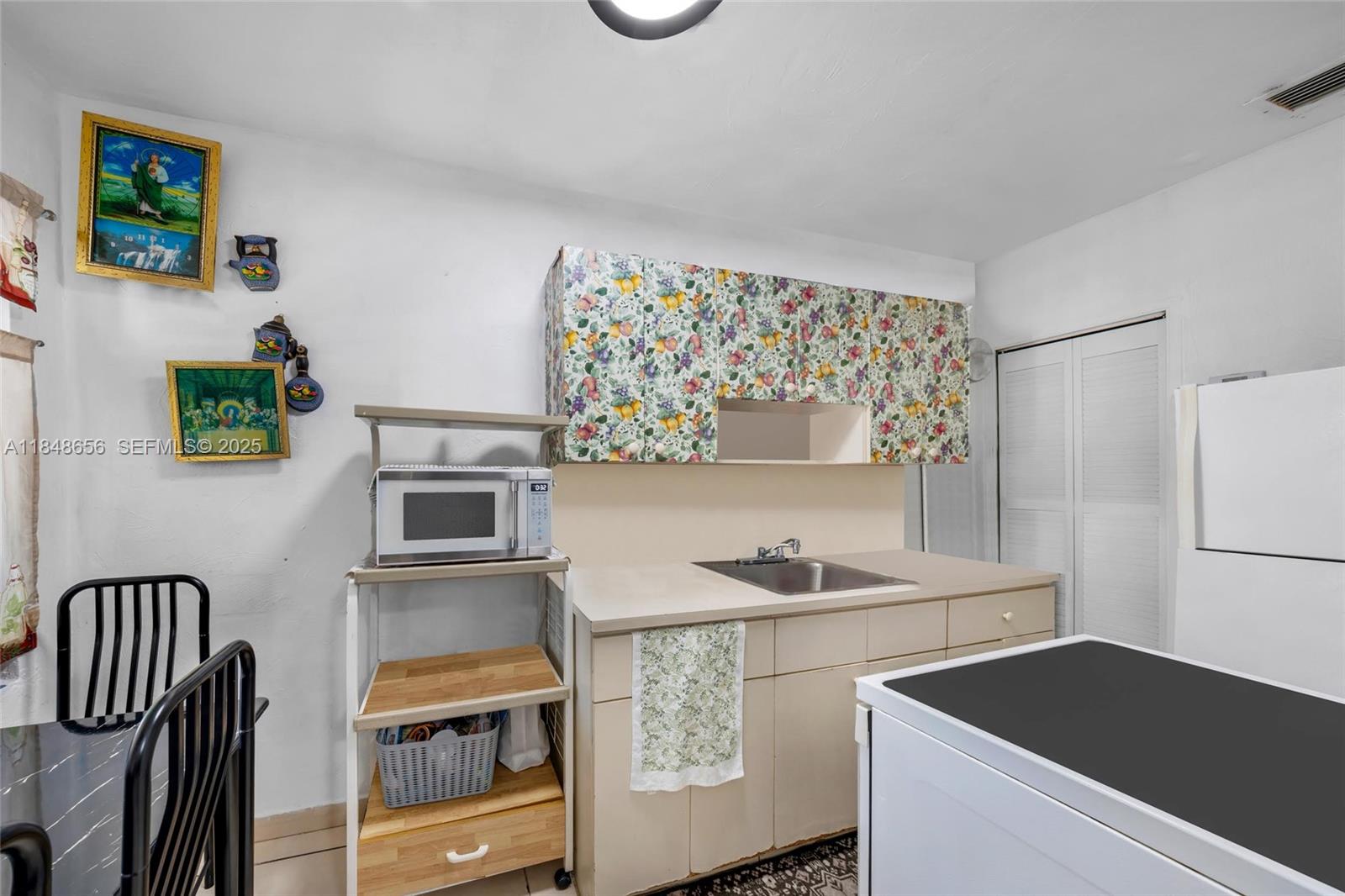 1858 Southwest 5th Street Miami, FL 33135 - Photo 7 of 23 a kitchen that has a cabinets and a stove top oven