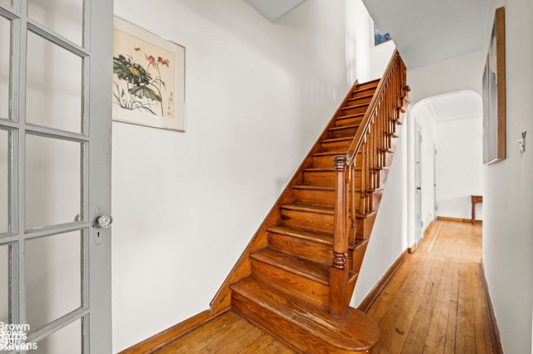 2954 Avenue R Brooklyn, NY 11229 - Photo 16 of 37 a view of staircase with wooden floor and white walls
