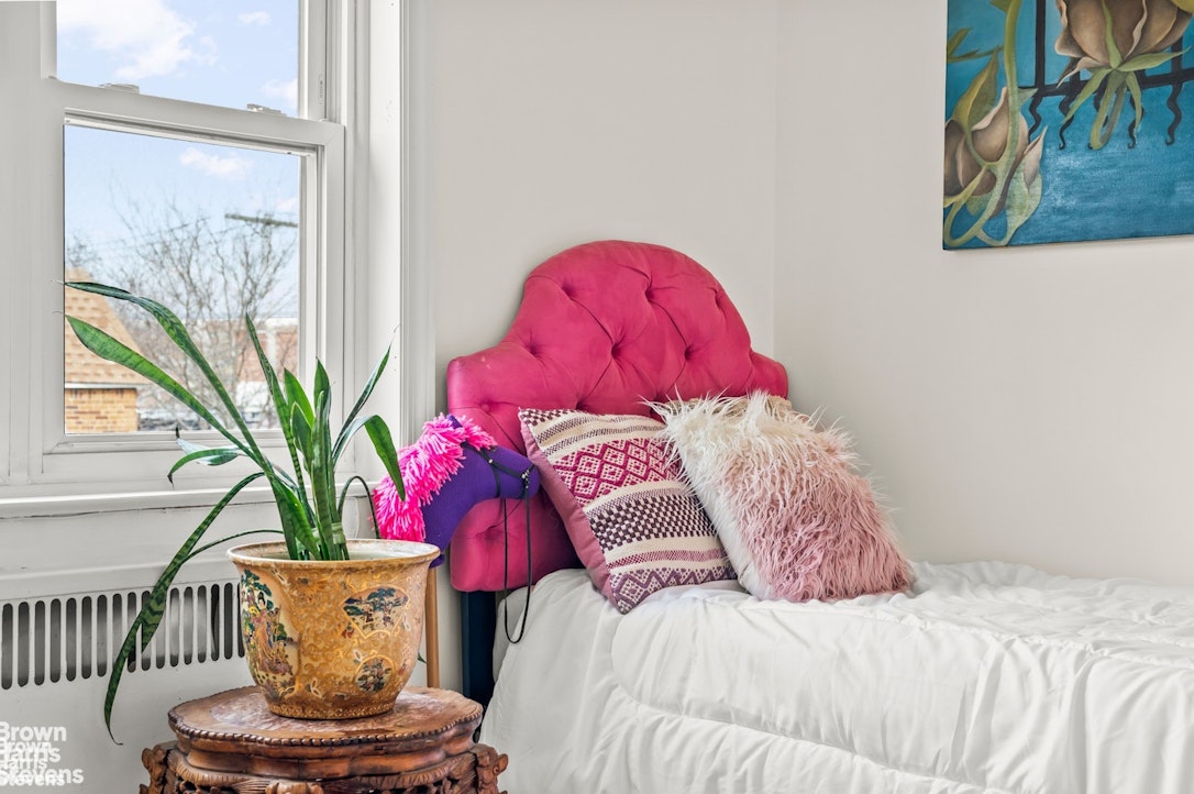 2954 Avenue R Brooklyn, NY 11229 - Photo 26 of 37 a bedroom with a bed and a potted plant