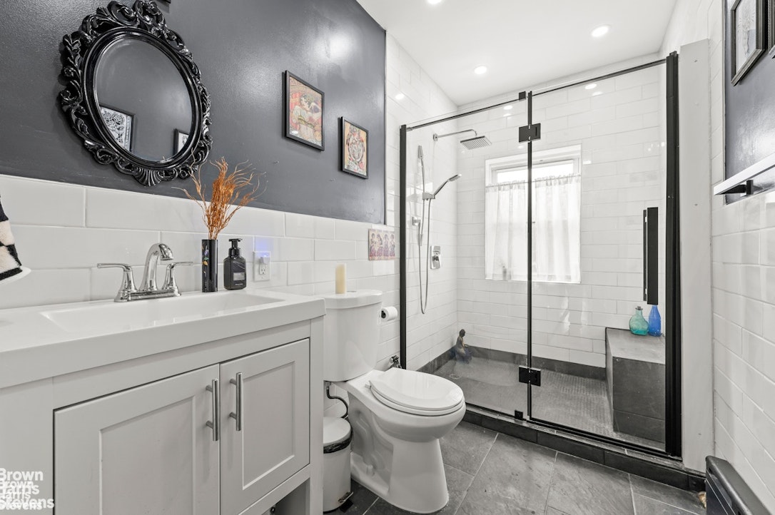 2954 Avenue R Brooklyn, NY 11229 - Photo 27 of 37 a bathroom with a toilet sink vanity granite and shower