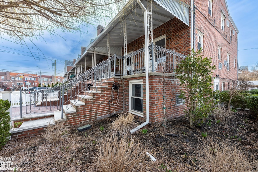 2954 Avenue R Brooklyn, NY 11229 - Photo 2 of 37 a yellow house with a yard and wooden fence