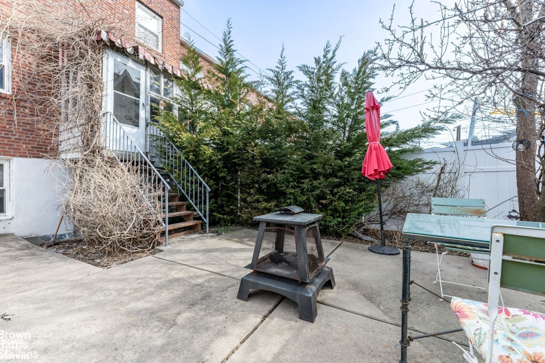 2954 Avenue R Brooklyn, NY 11229 - Photo 30 of 37 a backyard of a house with table and chairs