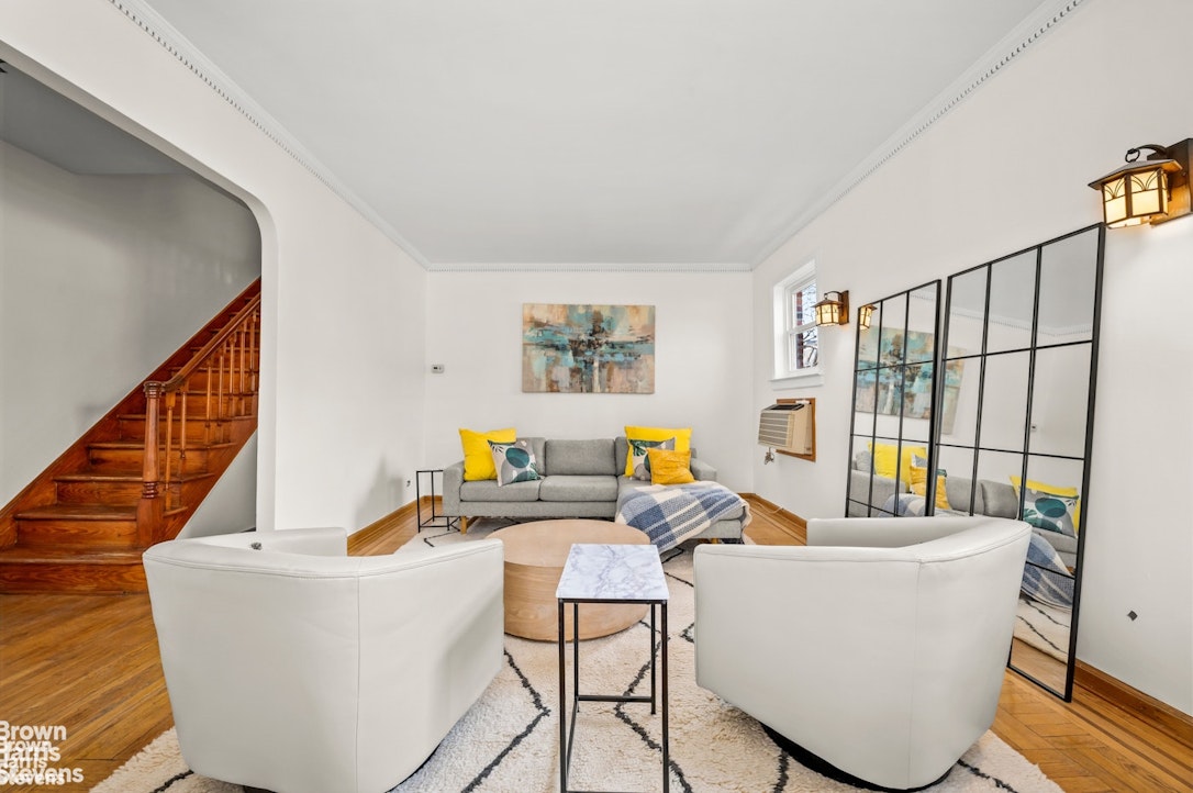2954 Avenue R Brooklyn, NY 11229 - Photo 6 of 37 a living room with couches and a dining table with wooden floor