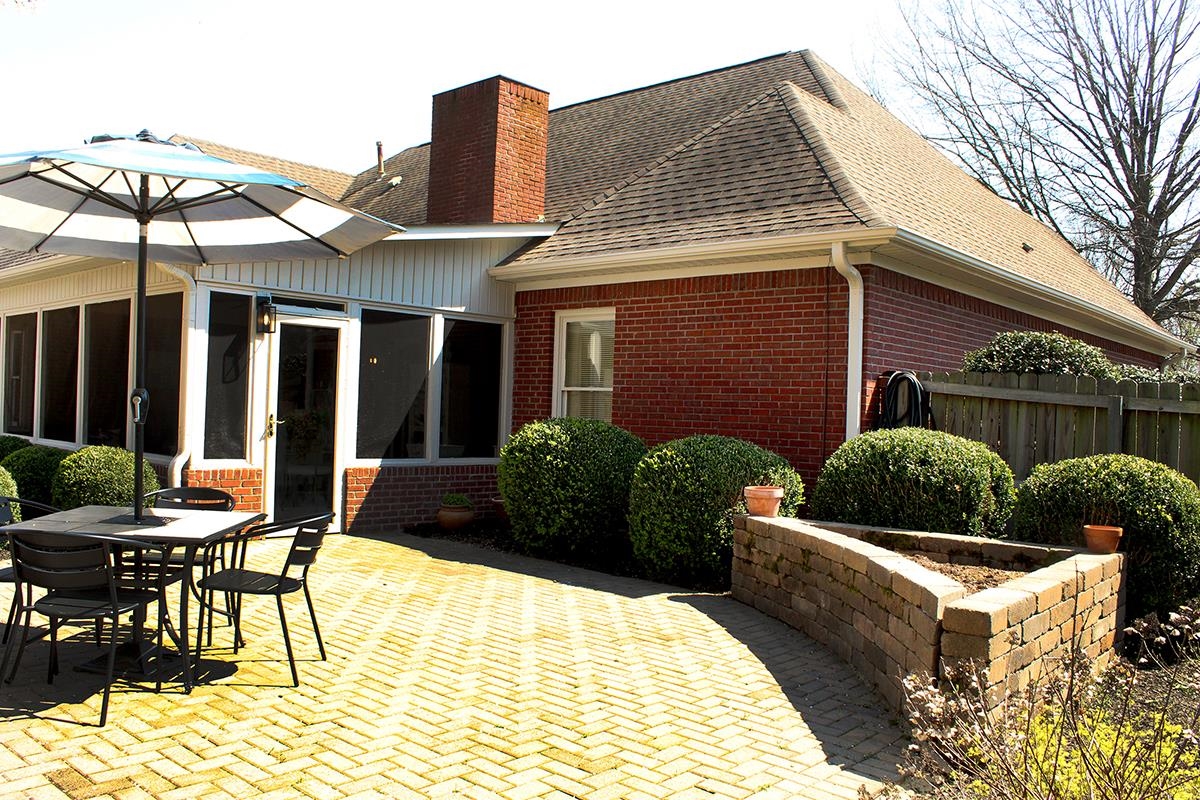 175 Windale Drive Jackson, TN 38305 - Photo 4 of 25 Rear view of house with outdoor dining space, roof with shingles, a patio, and brick siding