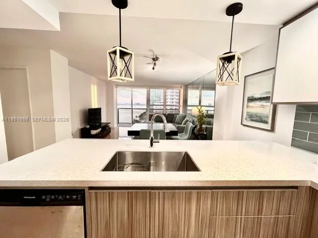 a kitchen with a sink a counter top space and a window