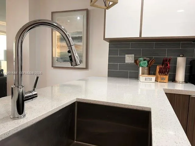 a kitchen with a sink and cabinets