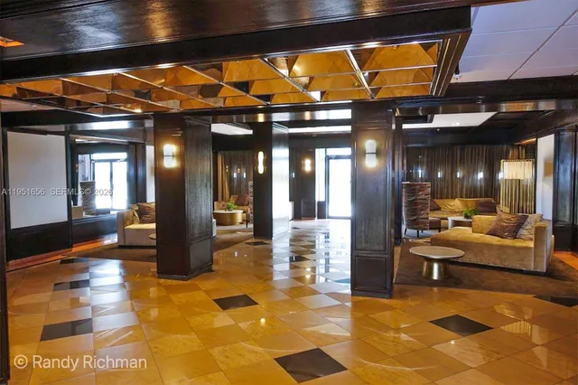 a lobby with furniture and rug