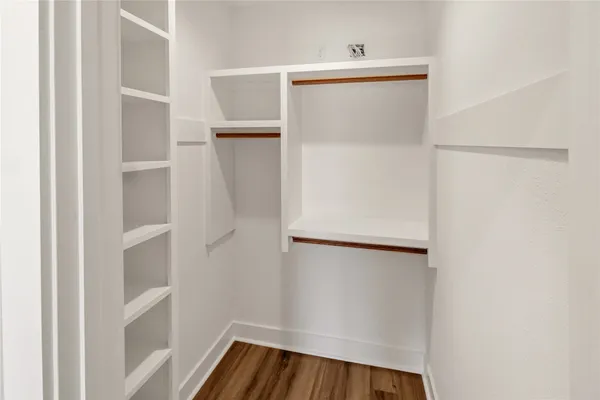 a view of walk in closet with empty racks