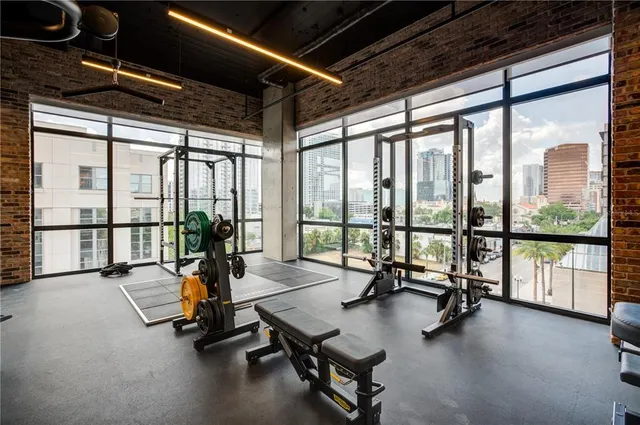 a view of a room with gym equipment and floor to ceiling window