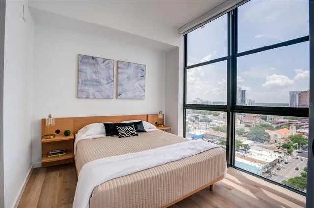 a bedroom with a bed and a large window