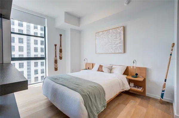 a bedroom with a bed and wooden floor
