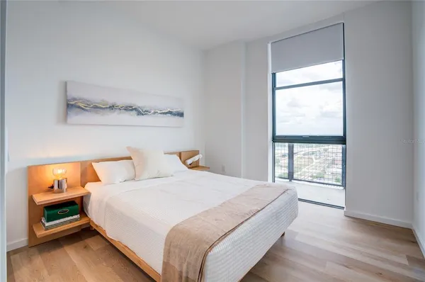 a bedroom with a bed and a window