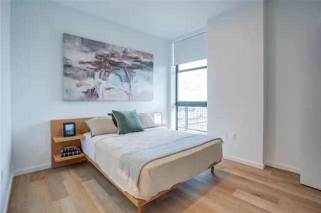 a bedroom with a bed and a window