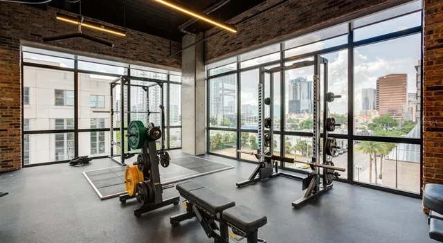 a view of a room with gym equipment and floor to ceiling window