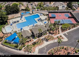 2600 Shakespeare Road Las Vegas, NV 89108 - Photo 6 of 6 An aerial perspective reveals a vibrant community hub, boasting multiple pools, tennis courts, and recreational amenities.