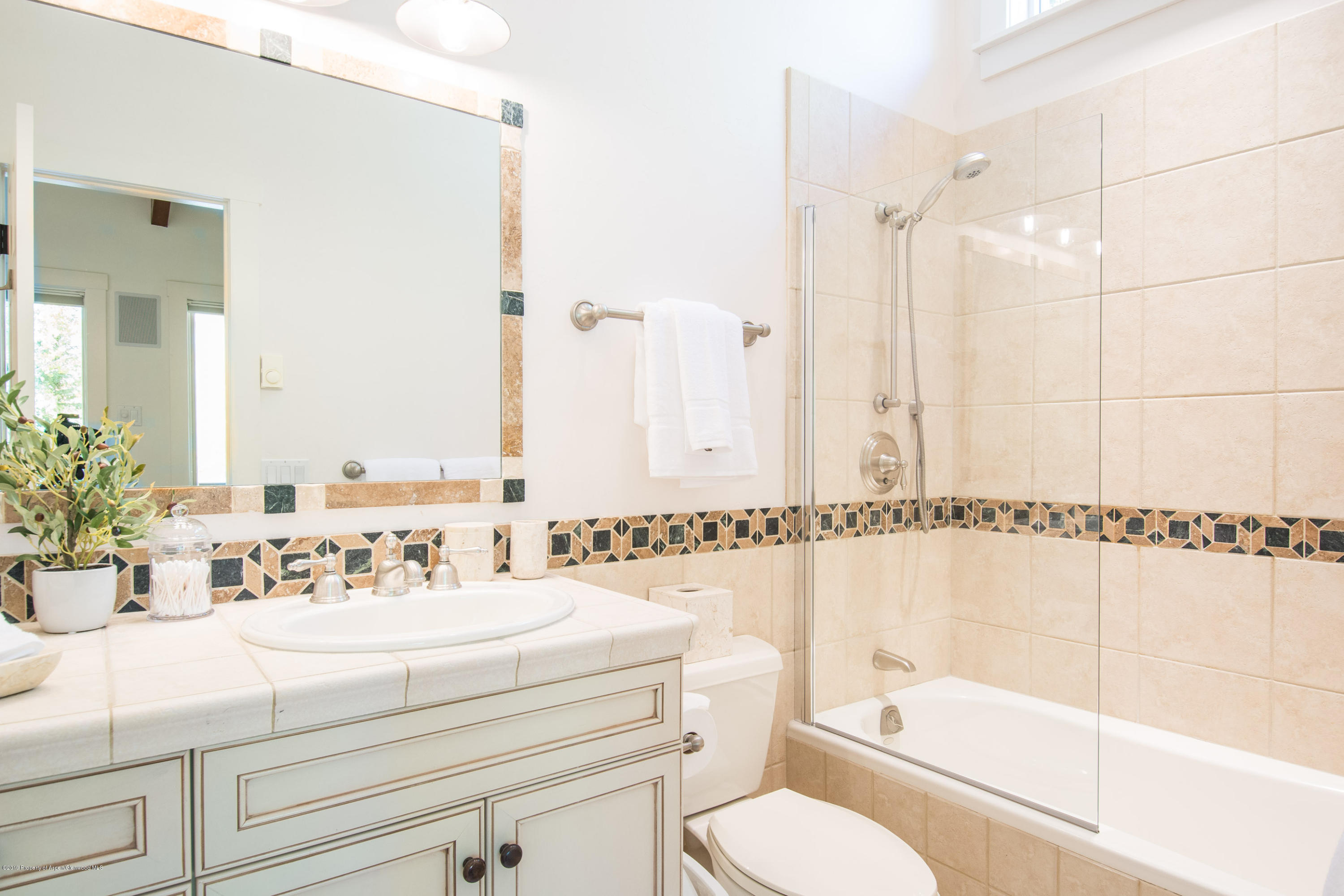 623 Faraway Road Snowmass Village, CO 81615 - Photo 20 of 30 a bathroom with a shower a sink and a mirror