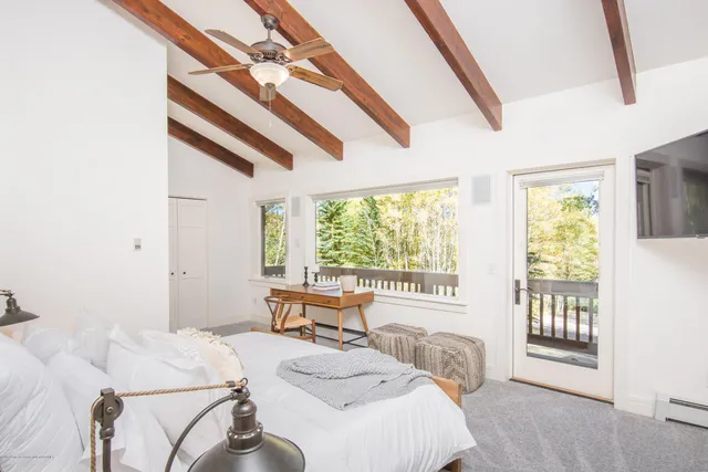 a bed sitting in a bedroom next to a window