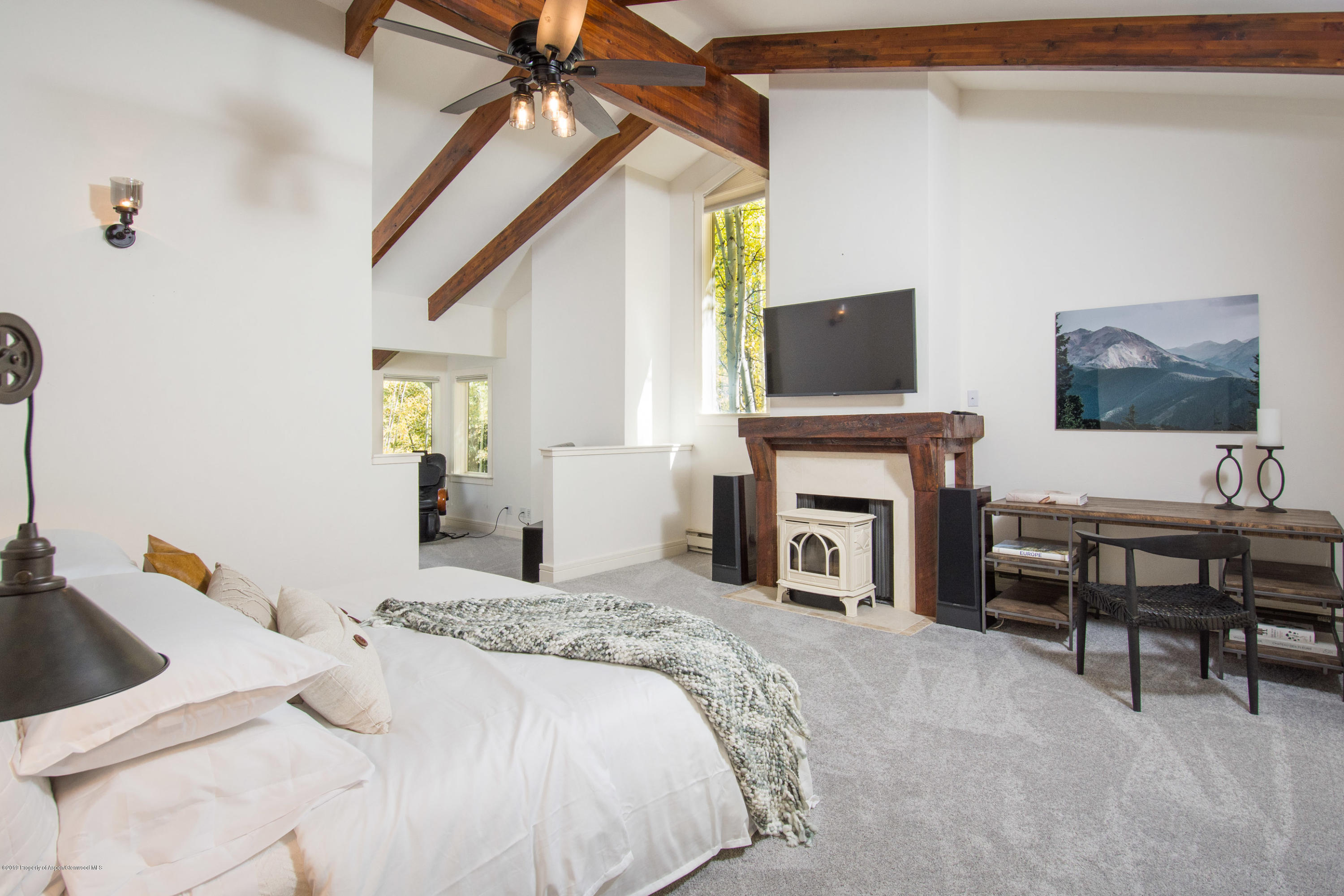 623 Faraway Road Snowmass Village, CO 81615 - Photo 7 of 30 a bedroom with furniture and a fireplace
