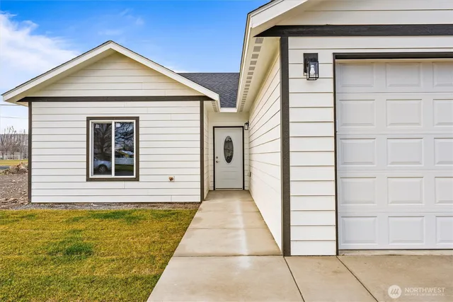 a large white kitchen with stainless steel appliances granite countertop a stove and a refrigerator
