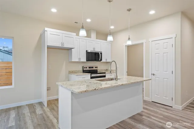a view of kitchen and window with wooden floor
