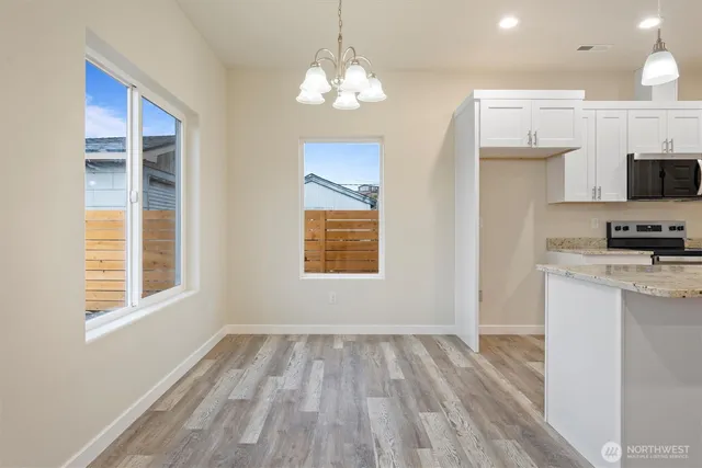 a view of kitchen and kitchen with a sink wooden floor kitchen view