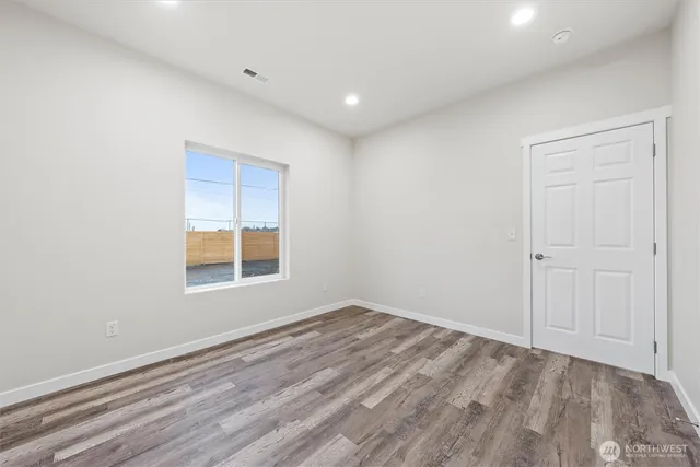a bathroom with a toilet a sink a mirror a bathtub and vanity