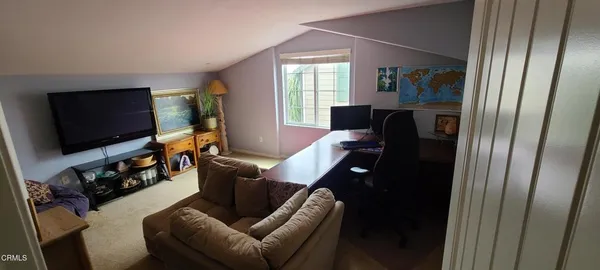 a view of a livingroom with workspace and a window