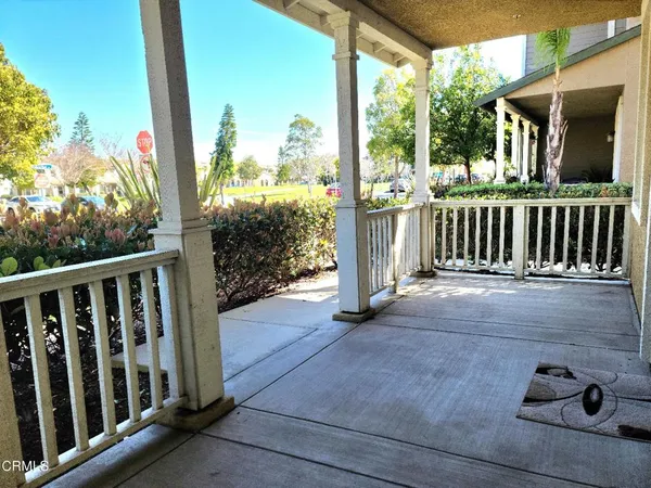 a view of a porch with wooden floor and fence