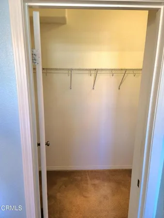 a view of an empty room with a closet