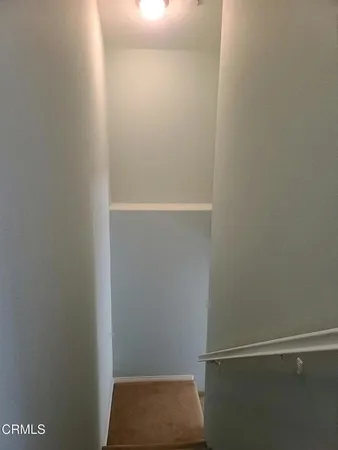 a view of a small space with wooden floor and window