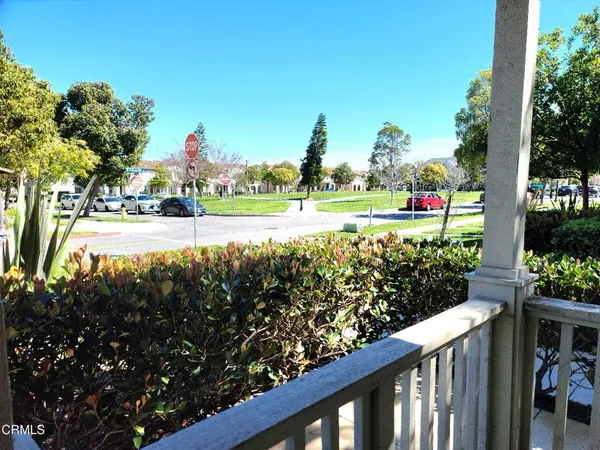 a view of a house with a yard and potted plants