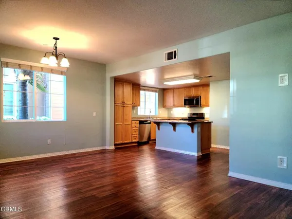 a kitchen with stainless steel appliances granite countertop a stove and a refrigerator