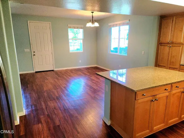 a kitchen that has a cabinets wooden floor and a window