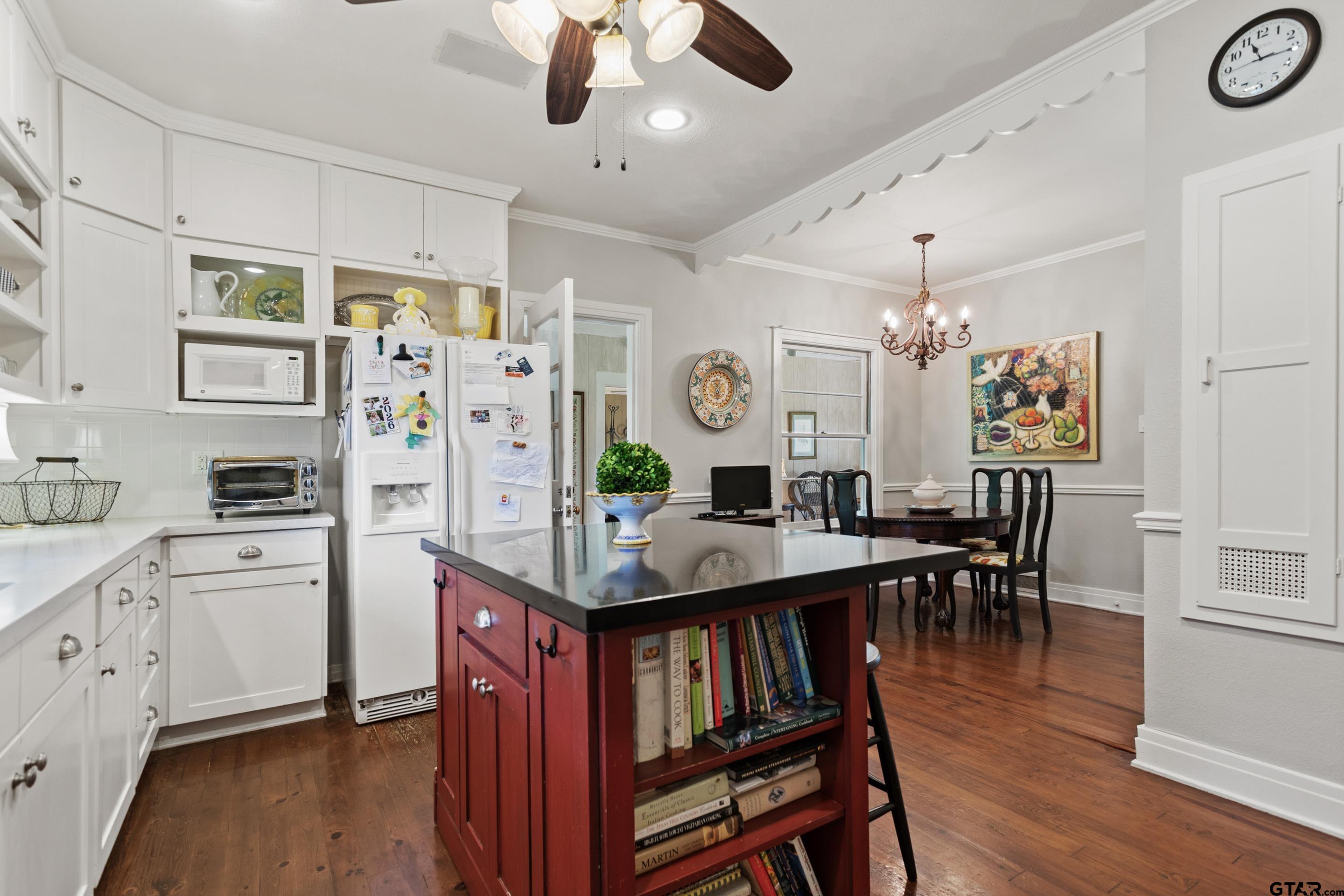 2631 Old Bullard Road Tyler, TX 75701 - Photo 25 of 43 a open kitchen with stainless steel appliances granite countertop a dining table chairs stove refrigerator and cabinets